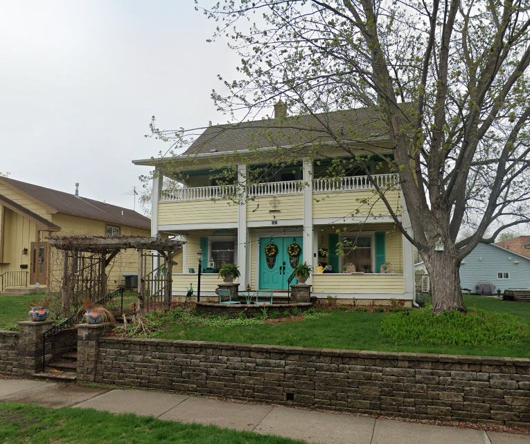 26 7th Avenue N before renovation - paint is old and yellow and landscaping is poor